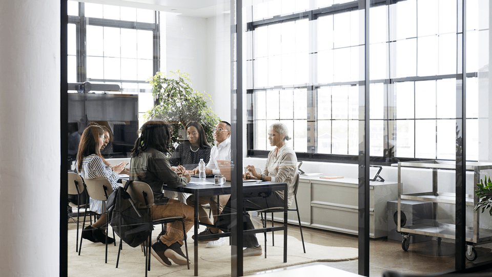 Marketing-team-conversing-in-meeting-room