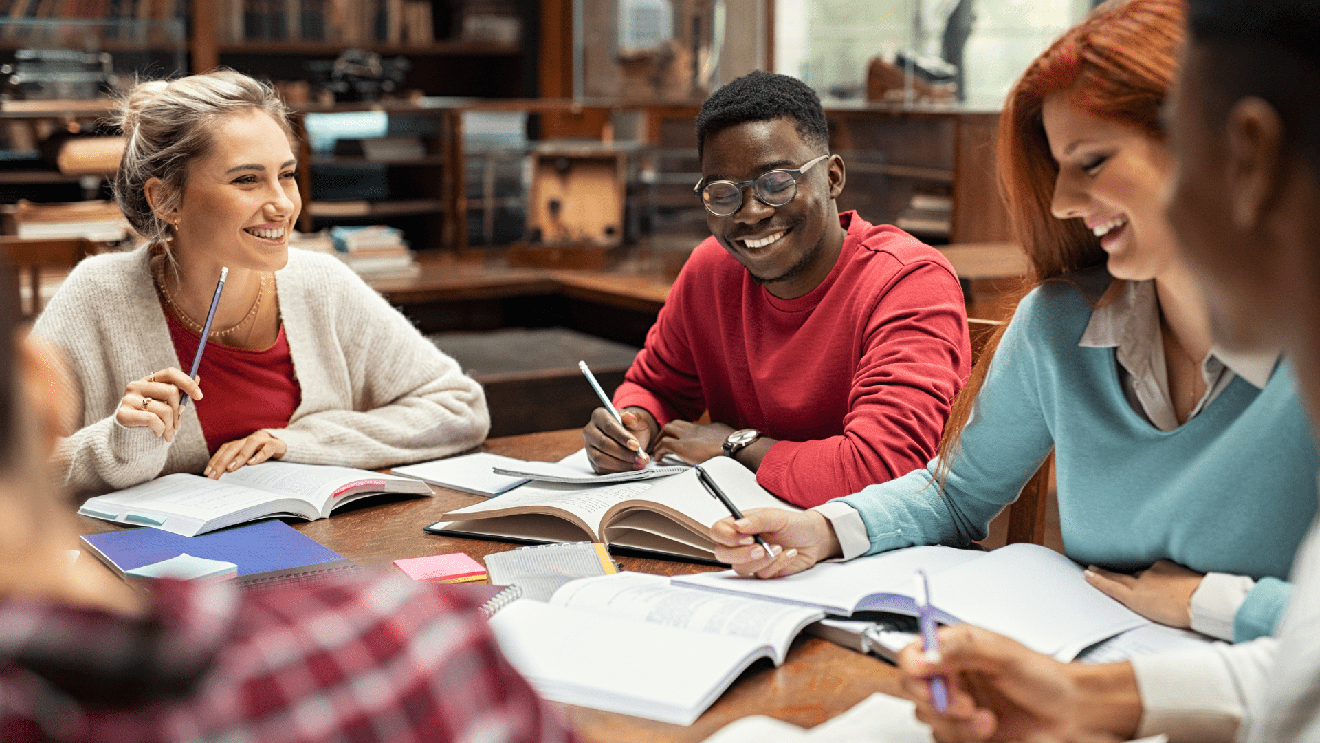 A group of students studying together and smiling in conversation