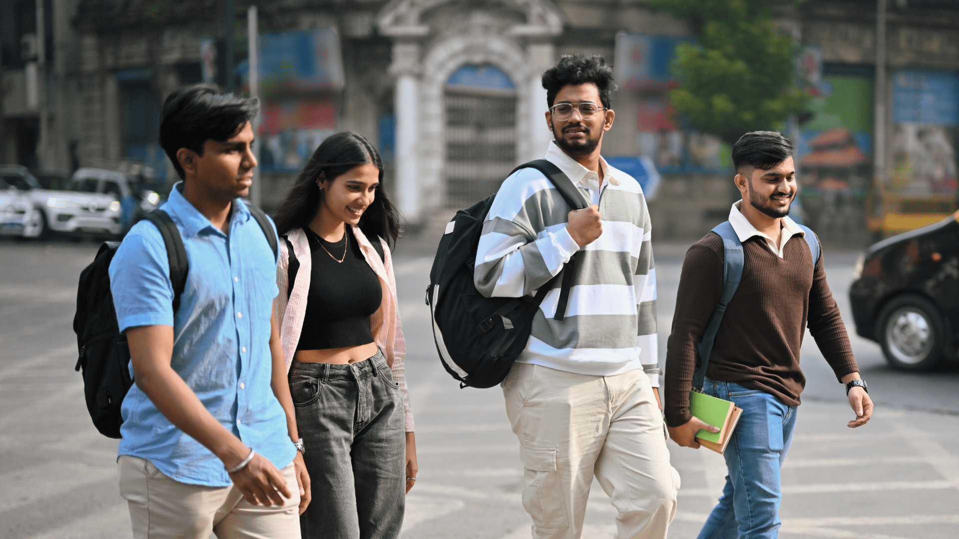 Four Indian students walking down the street