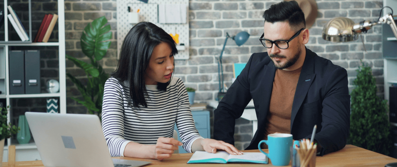 Man and woman working together at a desk