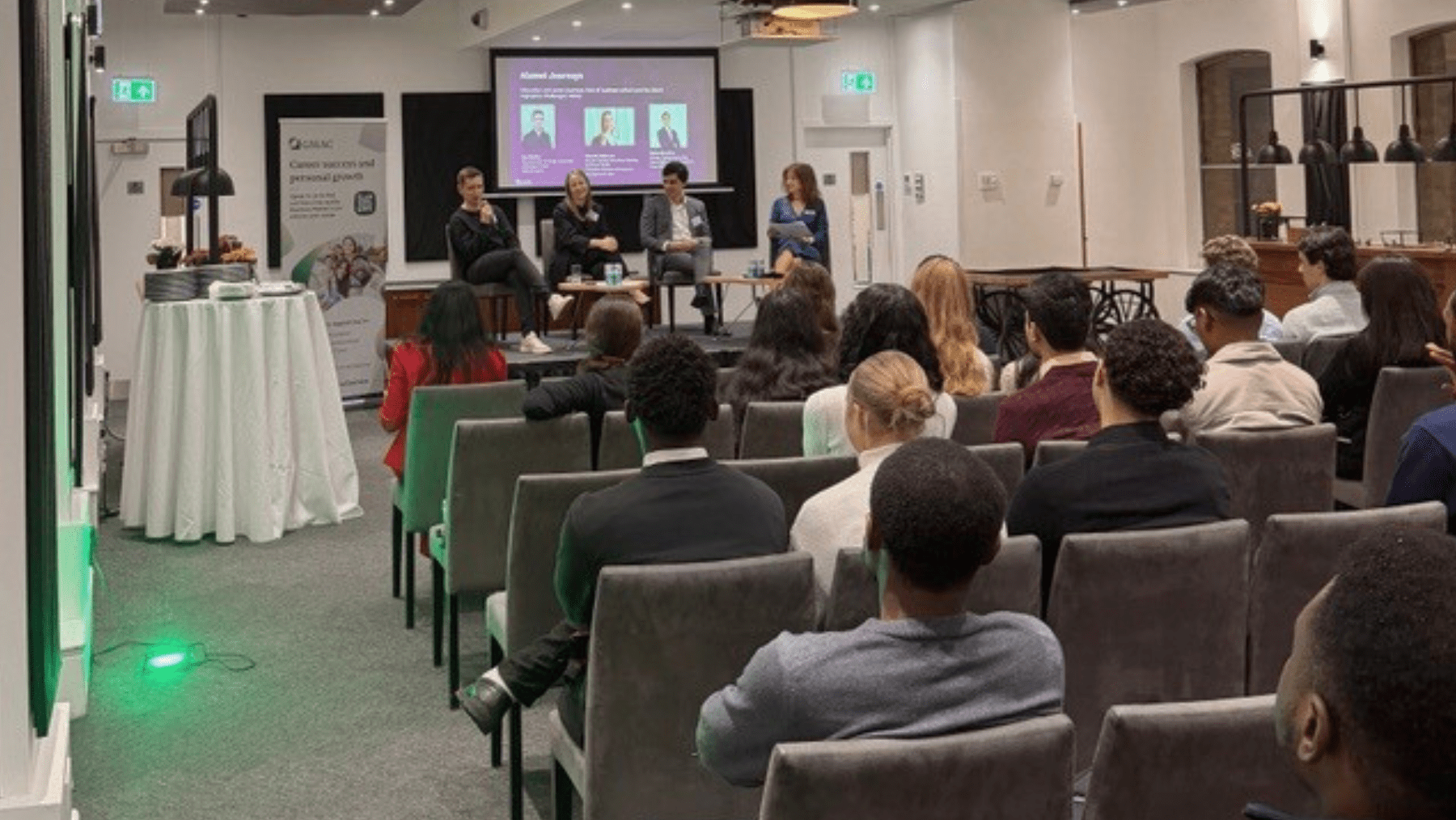 A group of students listening to a panel of school professionals