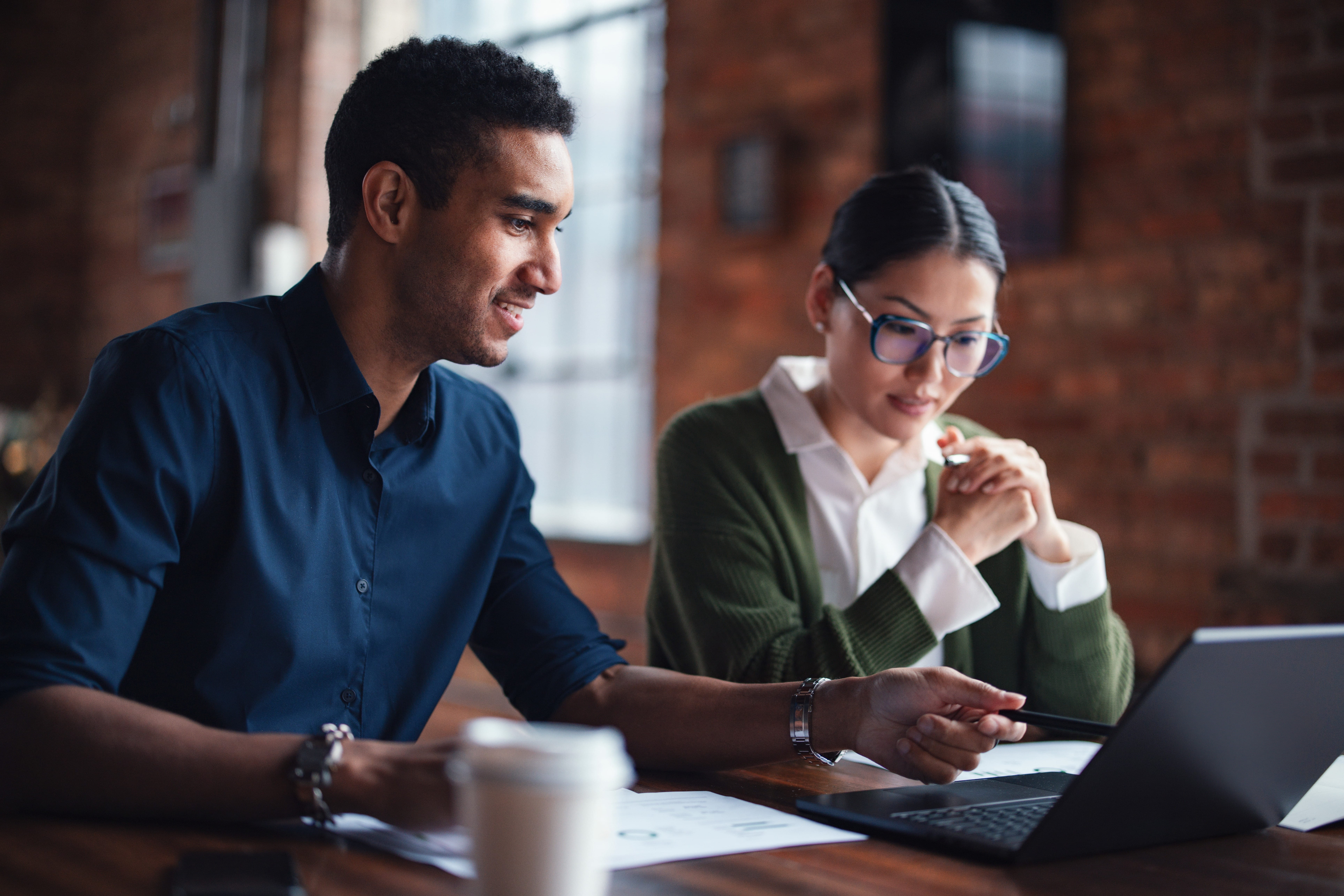 Man and woman looking at a computer screen together