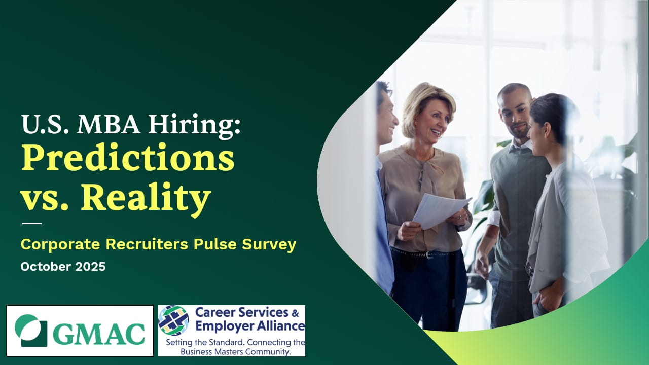 A group of four people in conversation smiling while holding documents