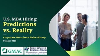 A group of four people in conversation smiling while holding documents