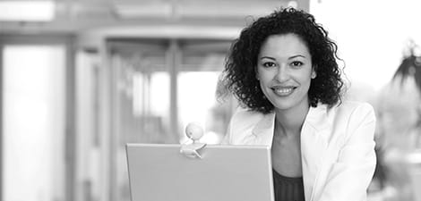 Woman sits through a MOOC course on her personal laptop.
