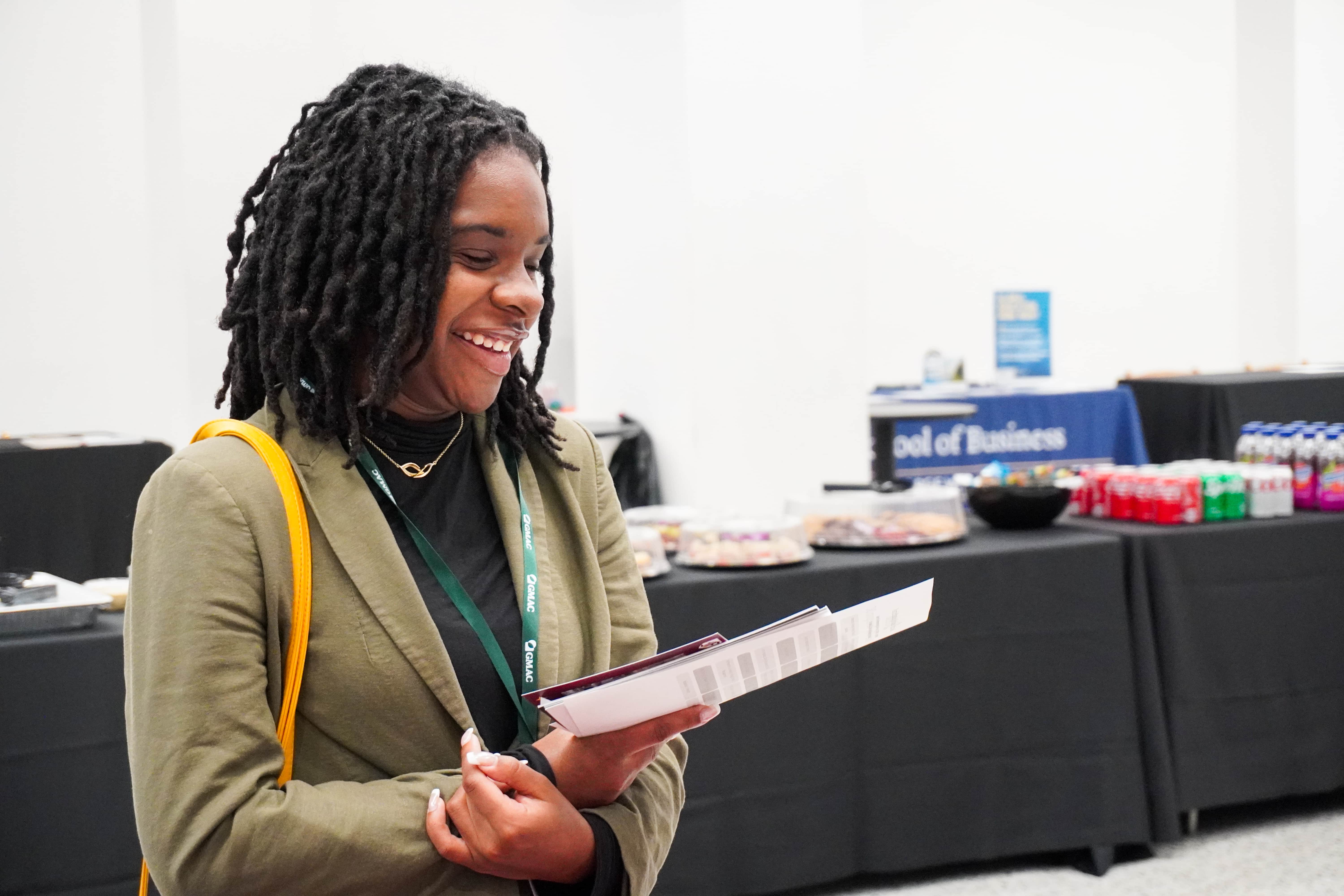 smiling woman at GMAC tours event