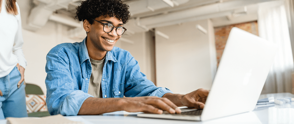 man working on laptop in airy office space