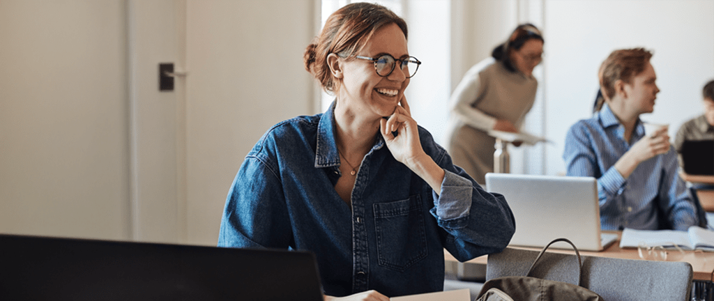smiling woman in classroom setting looking to side