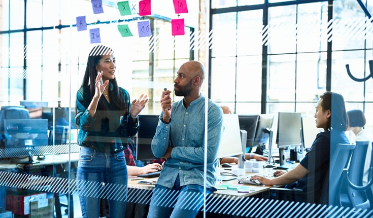 Two-Adults-Talking-In-Office