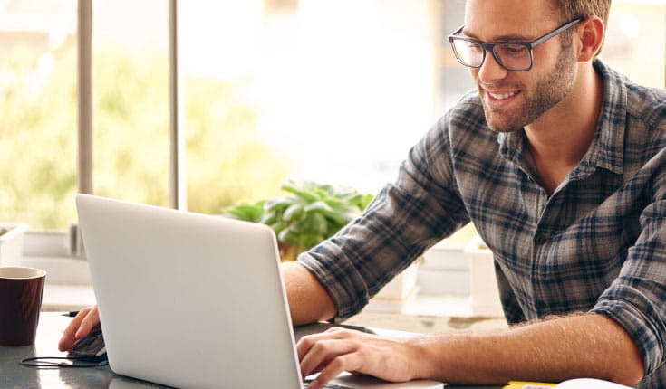 Smiling man at laptop