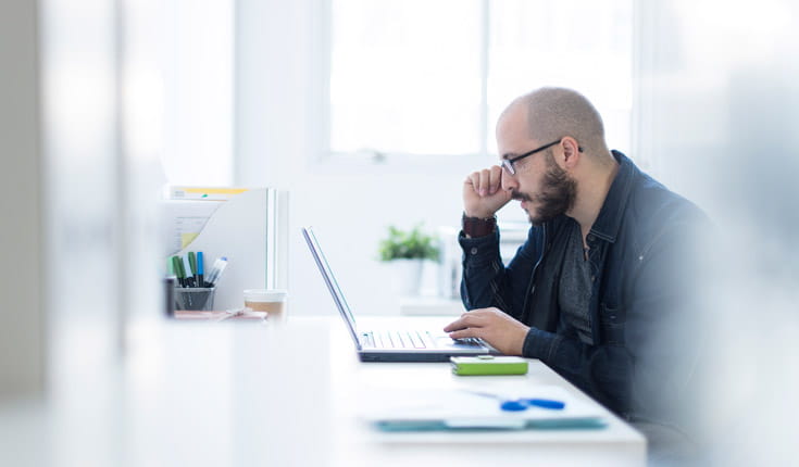 bearded man with laptop
