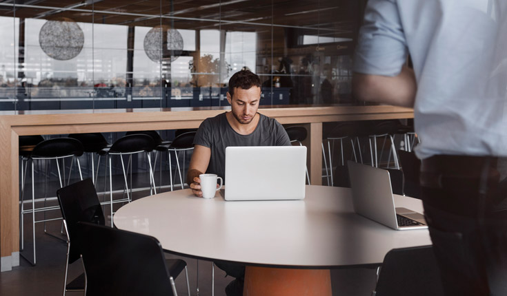 man with laptop in coffeeshop