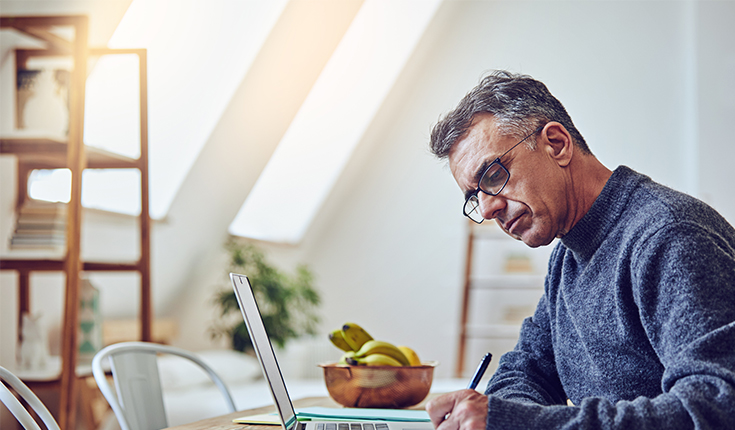 Man in Sweater Writes Longhand 
