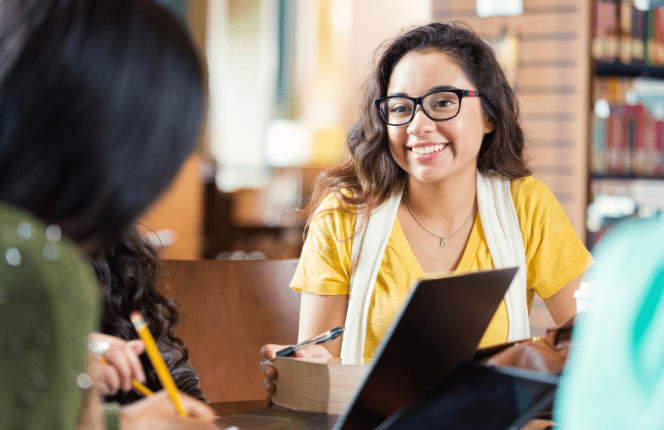 Young woman studying with others