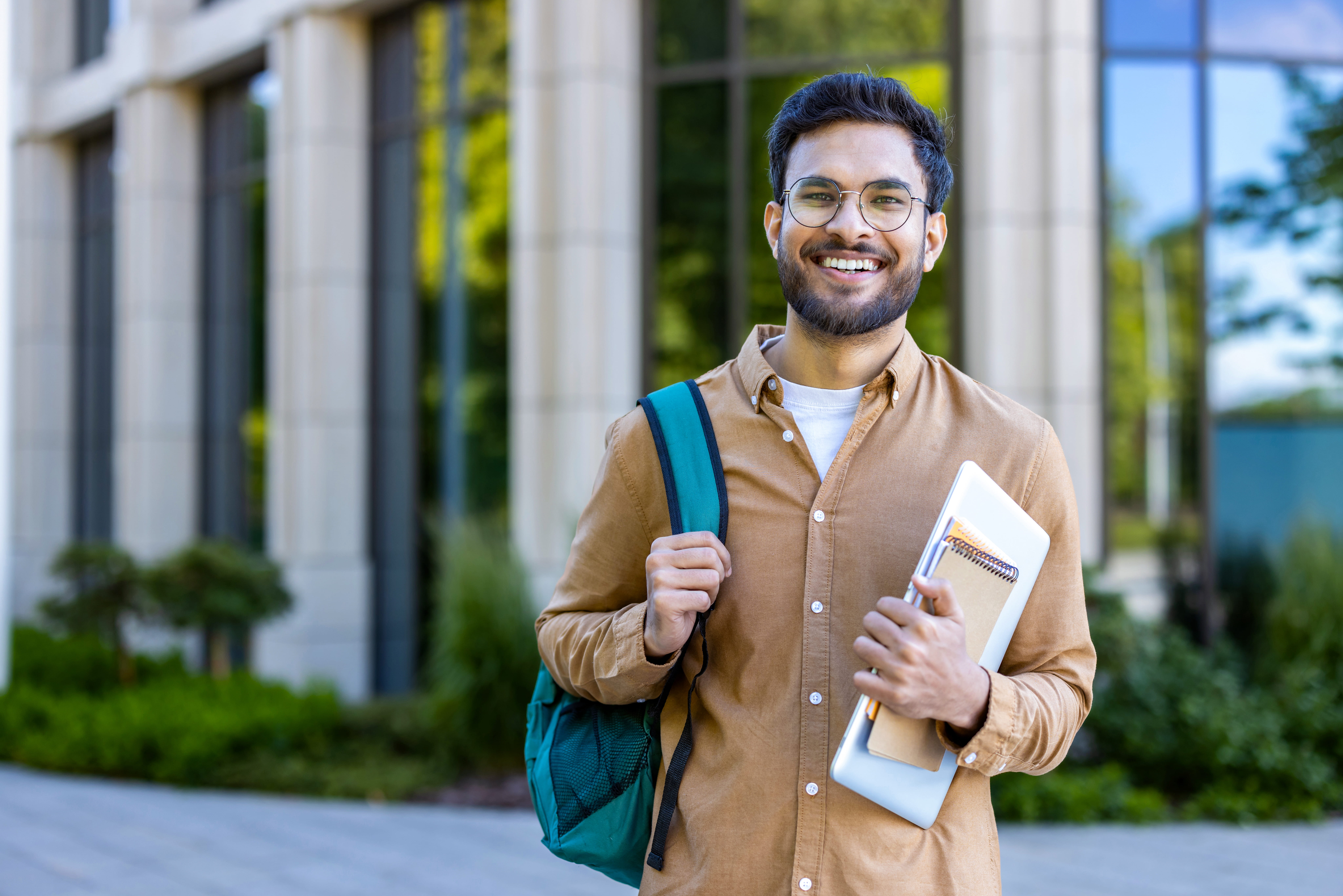 Young professional holding bag and notepad