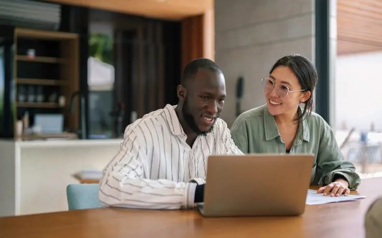 Man and woman sitting at a laptop at a desk
