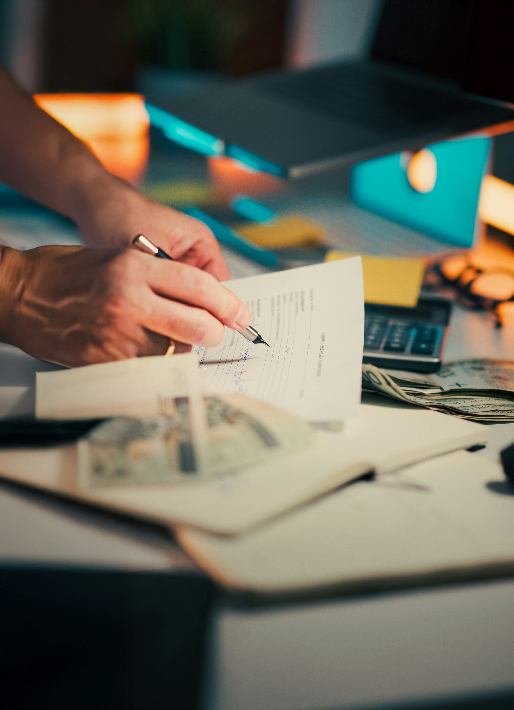 person tracking finances in notebook