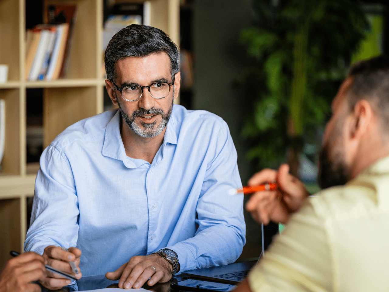 Two men speak in office during careers meeting 